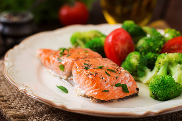 istock Baked fish salmon garnished with broccoli and tomato. 622191754