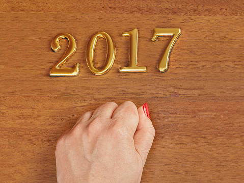Hand and numbers 2017 on door - new year concept background