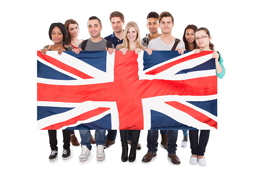 Happy Young People Holding Union Jack Against White Background
