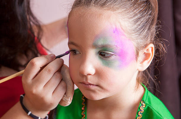 istock Little cute girl making facepaint before halloween party 622195192