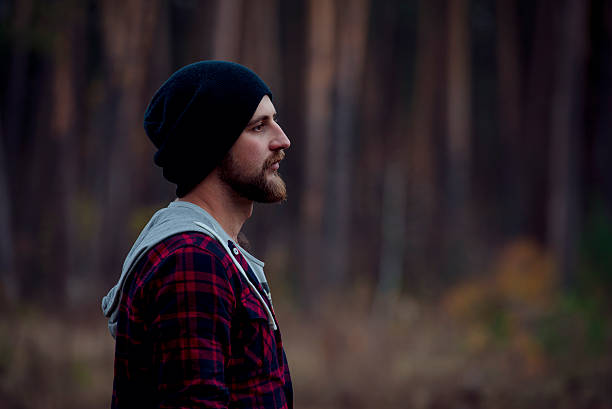 istock Portrait brutal bearded hipster man in the forest 622195740