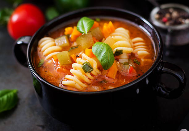 istock Minestrone, italian vegetable soup with pasta on wooden table 622196742