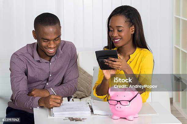 Happy Couple Calculating Bill Stock Photo - Download Image Now - Savings, Couple - Relationship, African Ethnicity