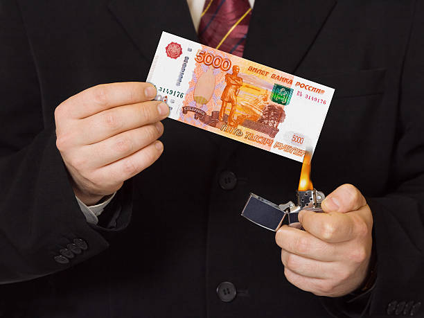 istock Hands and burnning russian money 622197320