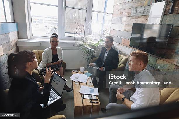 Young Business Colleagues Meeting In Modern Office Stock Photo - Download Image Now - Lobby, People, Business Meeting