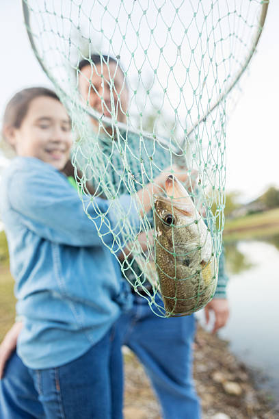 istock Excited girl catches fish with a net 622199872
