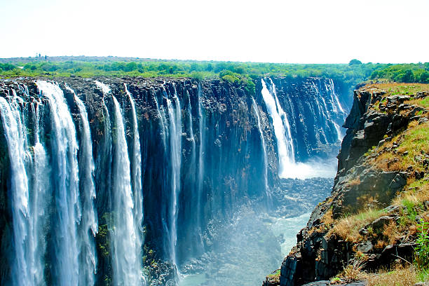 Victoria falls, on the border of Zambia and Zimbabwe Victoria Falls, waterfall in southern Africa on the Zambezi River at the border of Zambia and Zimbabwe landscape fog africa beauty in nature stock pictures, royalty-free photos & images