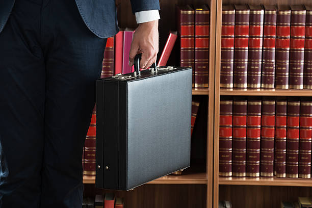 istock Lawyer Carrying Briefcase Against Bookshelf 622201818