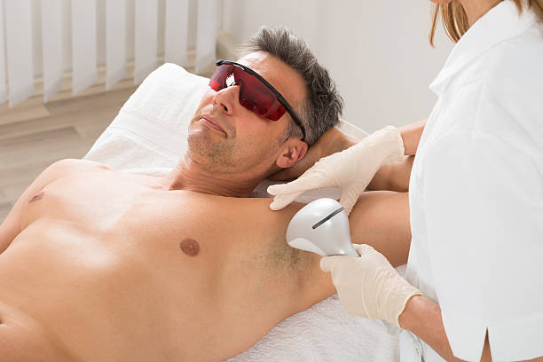 Beautician Giving Hair Removal Treatment To Man Stock Photo - Download  Image Now - Hair Removal, Medical Laser, Men - iStock