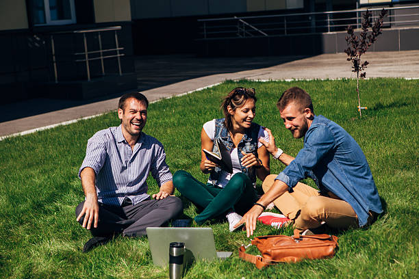 istock three students sit on the lawn and going to lessons 622204942