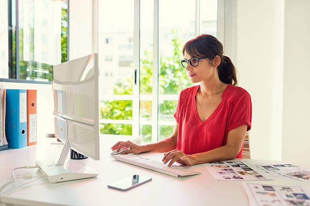 istock Executive financial mature woman working on computer at her workstation. 622206316