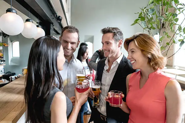 Group of business people having drinks after work at a restaurant