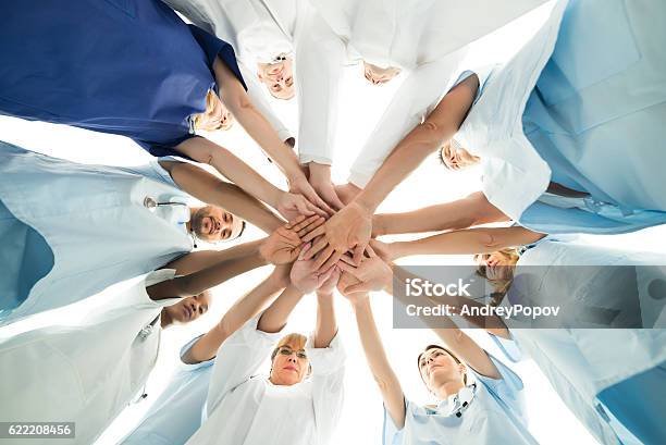 Multiethnic Medical Team Stacking Hands Stock Photo - Download Image Now - Healthcare And Medicine, Nurse, Teamwork
