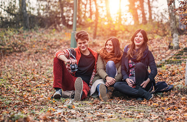 Group of people in park Group of friends enjoying outdoors in nature on a beautiful autumn day,. beautiful multi colored tranquil scene enjoyment stock pictures, royalty-free photos & images
