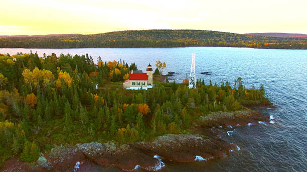Scenic Copper Harbor Michigan lighthouse with Autumn colors, at dawn, aerial view.