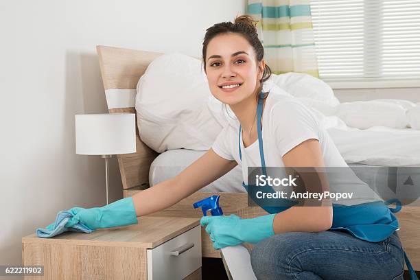 Female Housekeeper Cleaning Nightstand Stock Photo - Download Image Now - Cleaning, Housework, Service