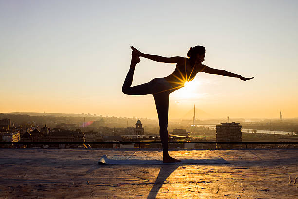 istock woman doing yoga on the rooftop 622212640