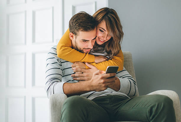 istock Beautiful young couple looking at smartphone 622213470