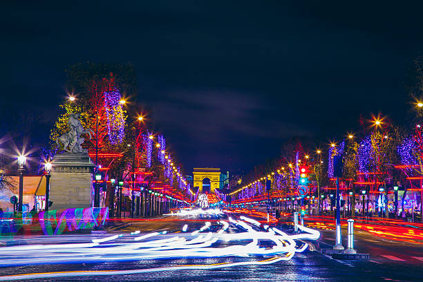 Avenue des Champs-Elysees and Arc de Triomphe Motion blurred cars on Champs Élysées and Arc de Triomphe with Christmas city lights avenue des champs elysees photos stock pictures, royalty-free photos & images