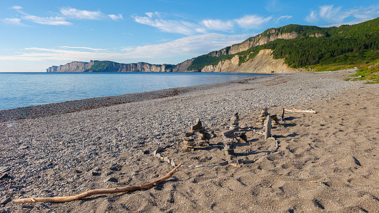 The beach at Fourillon national park in Quebec, Canada. Cliffs in the background lead to Cap Gaspe, the easternmost point of the Gaspe peninsula.