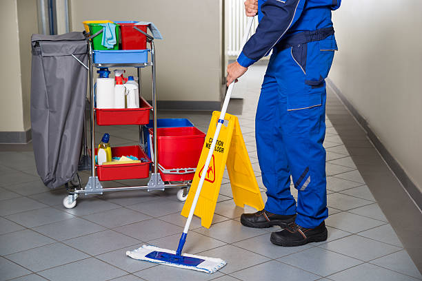 janitor with broom cleaning office corridor - caretaker imagens e fotografias de stock