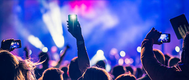istock People filming a concert 622215408