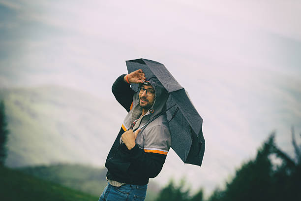 istock Man in nature holding umbrella. 622215630