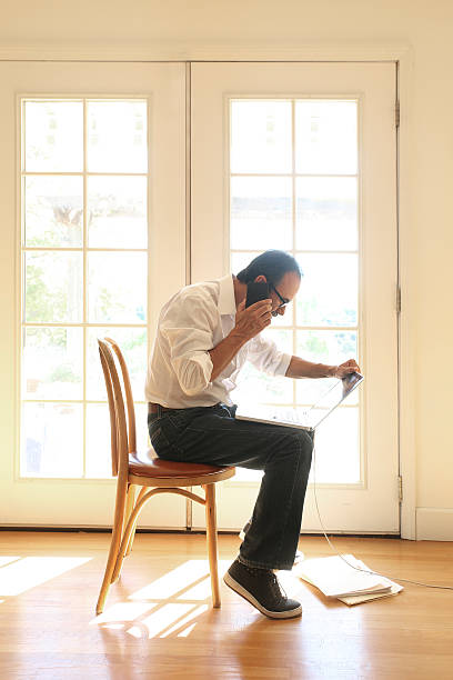 istock Hispanic Man Talking On Cell Phone Sits In Chair 622215742