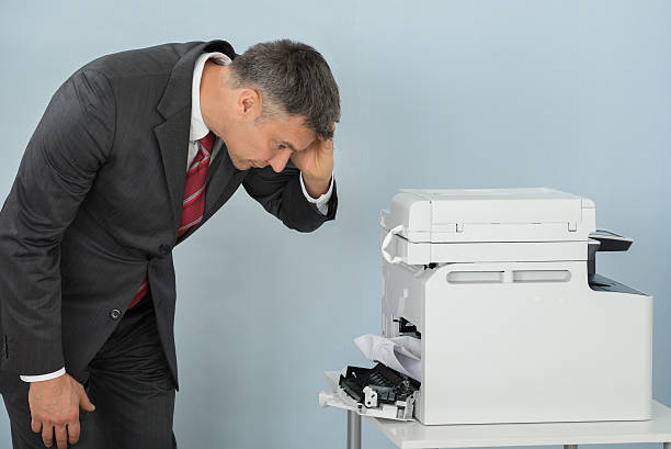 istock Businessman Looking At Printer Machine At Office 622216160