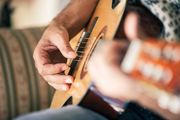 istock Adult Man playing on Acoustic Guitar 622220040
