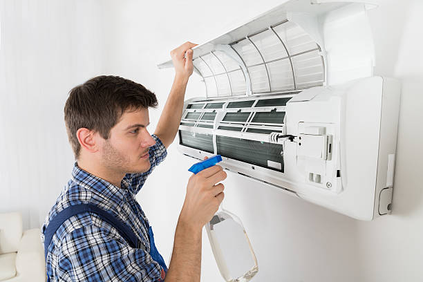 istock Male Technician Cleaning Air Conditioner 622225352