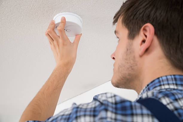istock Electrician Repairing Fire Sensor 622225432