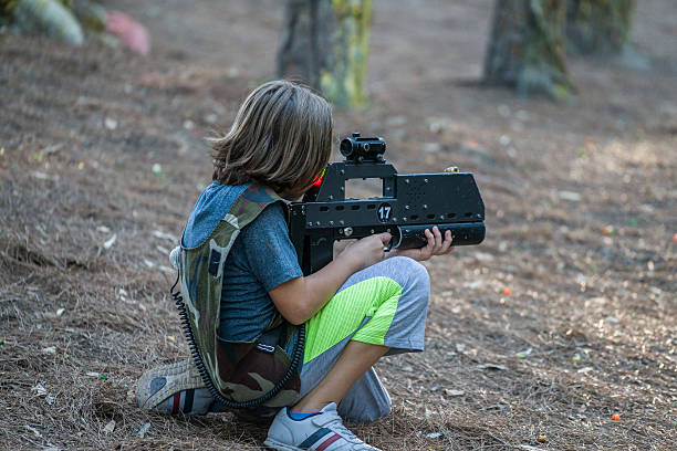 Little boys playing with gun during laser tag