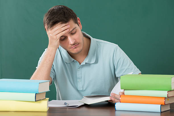 istock Man With Books At Desk 622277126