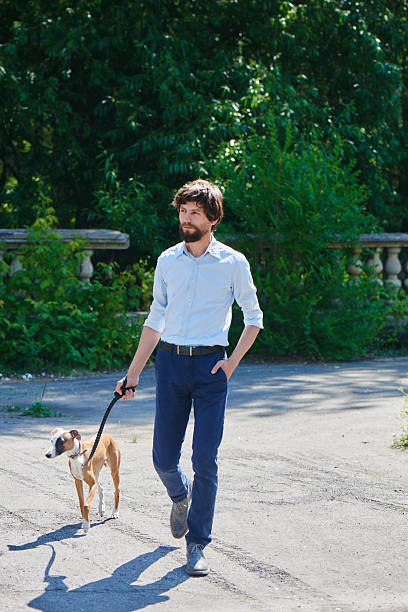 istock Man in walks with a dog in the Park 622277384