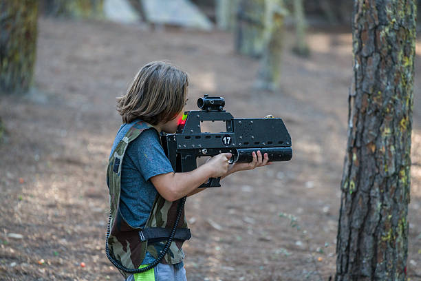 istock Little boys playing with gun during laser tag 622277514