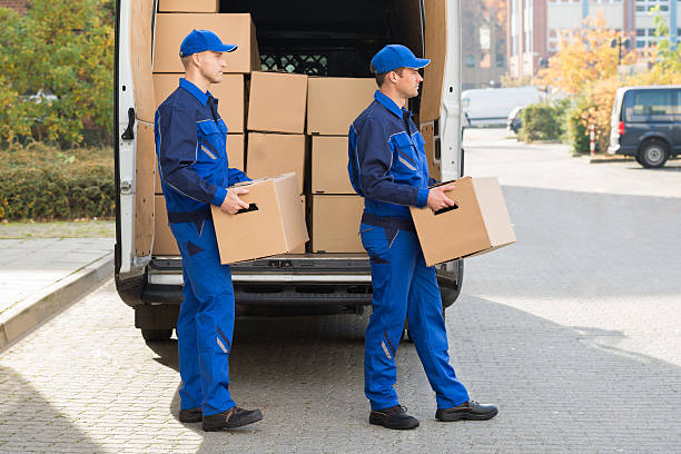 istock Delivery Men Carrying Cardboard Boxes 622277542