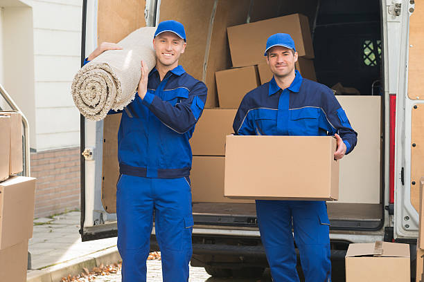 happy delivery uomini che trasportano scatola di cartone e tappeto - moving van relocation truck box foto e immagini stock