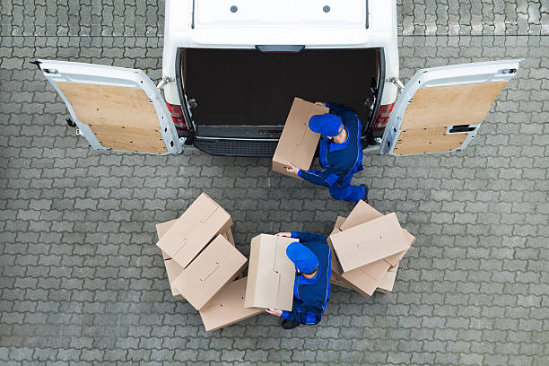istock Delivery Men Unloading Cardboard Boxes From Truck On Street 622277750
