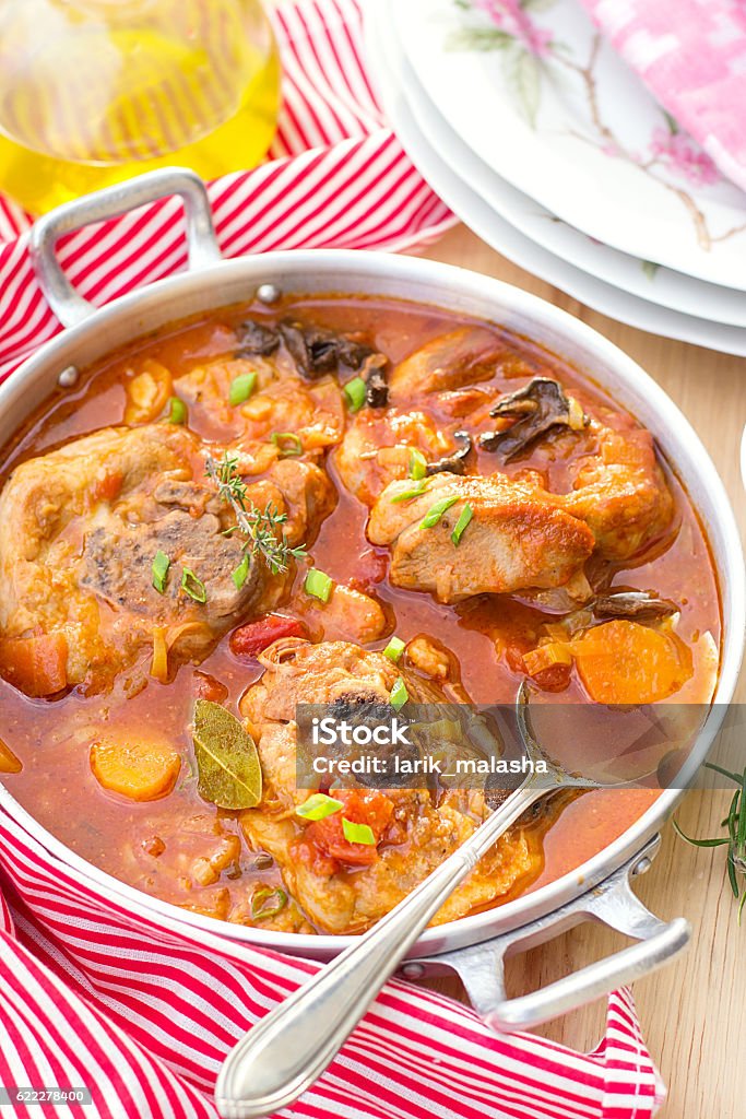 Turkey ossobuco osso buco in tomato gravy with mushrooms Turkey ossobuco osso buco in tomato gravy with mushrooms and vegetables Affectionate Stock Photo