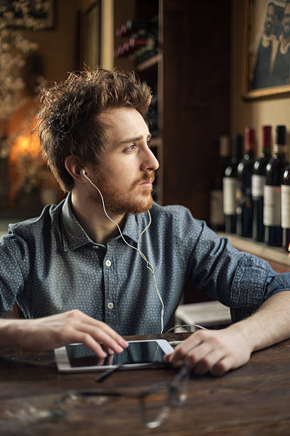 istock Hipster listening to music with his tablet 622279934