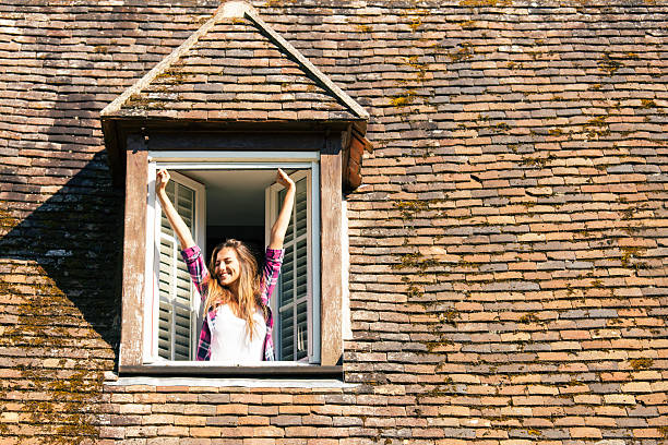 istock Young woman stretching on rooftop window 622281626