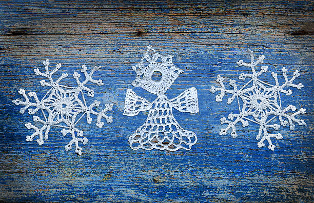 Blue wooden background with snowflakes and angel stock photo