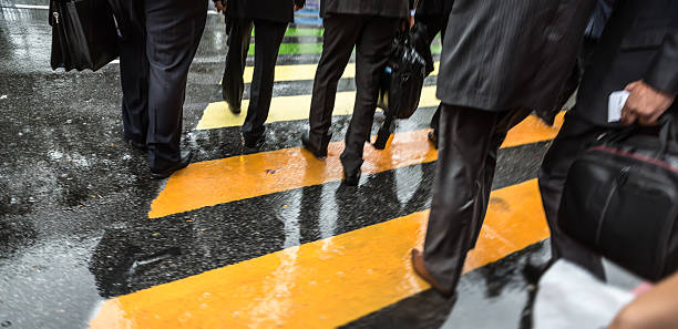 istock People cross street at rainy day 622283614