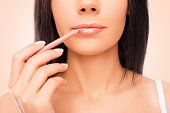 Close up of young woman doing maquillage with lip's liner