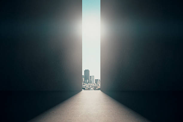 Abstract opening in wall Abstract opening in wall with bright daylight and city view in concrete interior. Success concept. 3D Rendering light at the end of the tunnel stock pictures, royalty-free photos & images