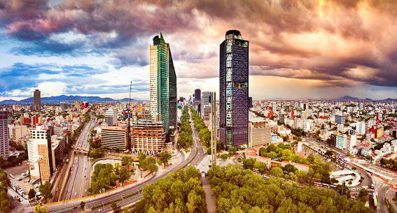 Panoramic aerial view of Mexico City skyline at dusk.