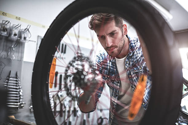 istock Mechanic repairing bicycle tire 622287338