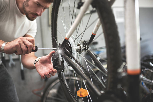 istock Mechanic repairing bicycle wheel 622287562