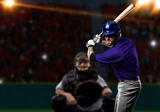 Baseball Player Baseball Player with a blue uniform on baseball Stadium. home run photos stock pictures, royalty-free photos & images